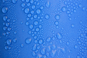 Fototapeta na wymiar Water drops on blue curve paper cup
