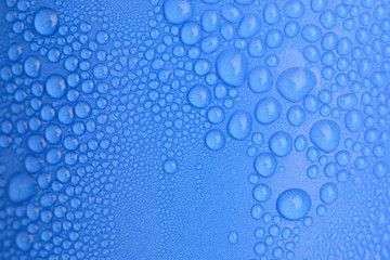 Water drops on blue curve paper cup