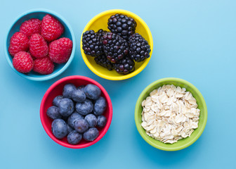 Berries and oatmeal in bowls