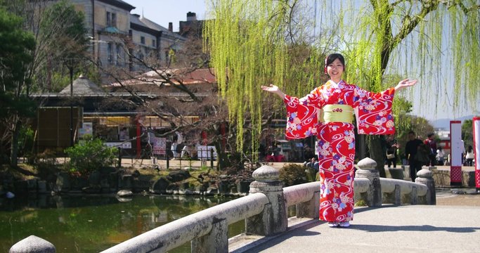 Beautiful Japanese Girl in Kimono Welcomes you to Kyoto wide shot