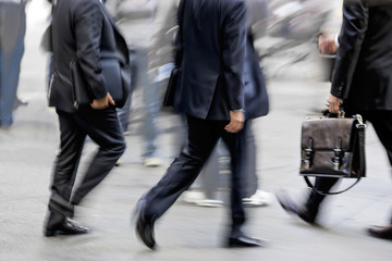 motion blurred business people walking on the street