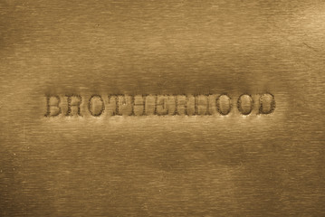 word brotherhood printed on metallic background