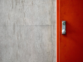 Cement concrete wall texture with modern red door.