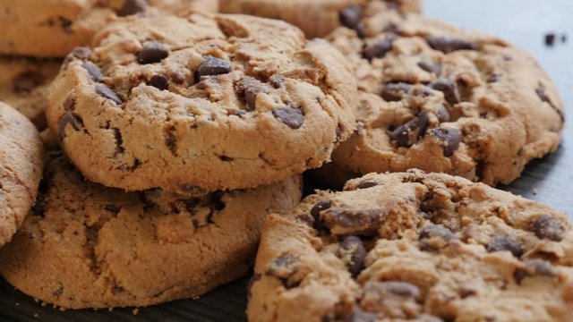 Chocolate chip cake cookies on the wooden table slow panning 4K 2160p UltraHD footage - Arranged on wooden surface chocolate cookies pan 4K 3840X2160 UHD video 