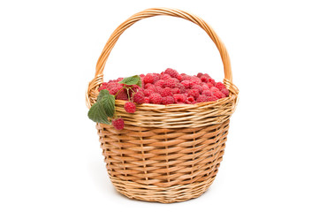 Fototapeta na wymiar Fresh ripe red raspberries in a wicker bowl 