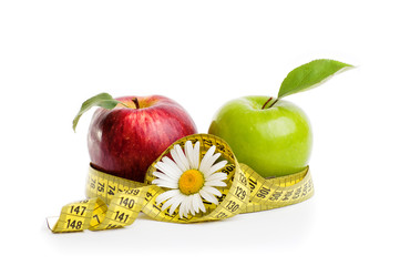 Apples, flowers and measuring tape. 