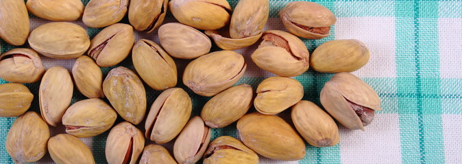 Pistachio nuts on checkered tablecloth, healthy eating