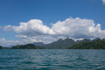 Beautiful mountains behind fog in Ratchaprapha Dam at Khao Sok N