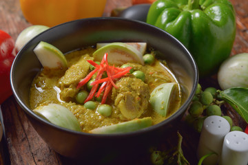 Thai chicken green curry with old wooden background