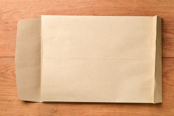 Blank paper and envelope on wooden background