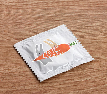 Condom with pictures on wooden table