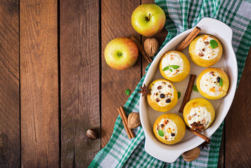 Obraz na płótnie Canvas Appetizing baked apples with cottage cheese and raisins. Top view