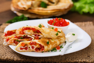 Pancakes with red caviar and cream cheese