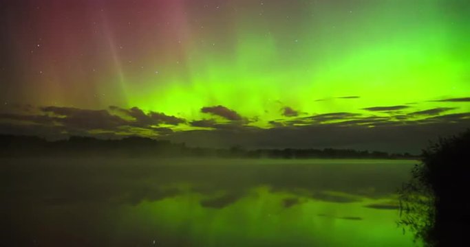 Aurora Borealis (Northern Lights) over a river covered in mist
