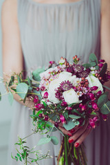Close up image of bridesmaid with a bouquet of wedding flowers