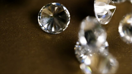 Diamonds Fall On Golden Surface Super Slow Motion. Close Up Macro - Powered by Adobe