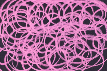 bright pink colored chalk circle graphic lines on blackboard. abstract background.