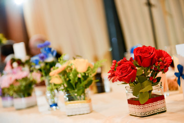 Bouquet of roses sitting on a wedding table