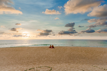 A pair of lonely tourist sitting at the beach on Phuket