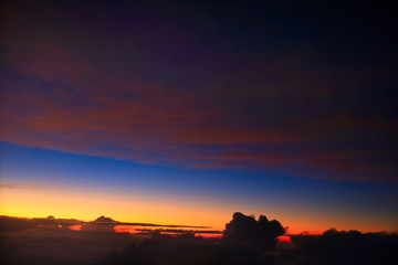 A pre-dawn sky above the clouds over Indonesia taking during a flight at 35,000ft.