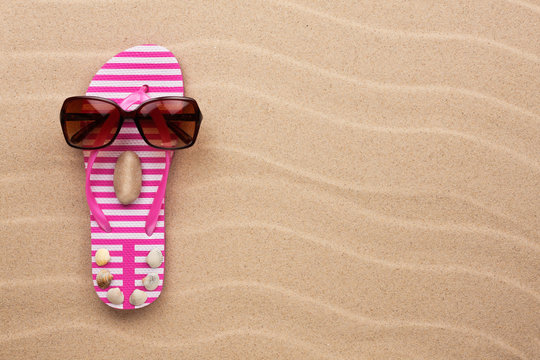 Concept of a woman's face, flip-flops and sunglasses