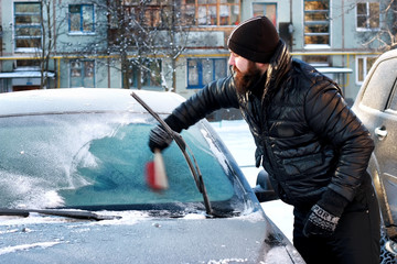 winter man brush car snow