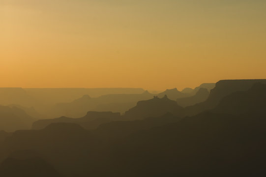 Panoramic View of Grand Canyon in amber colors after sunset