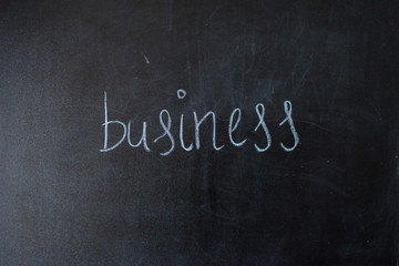 Obraz premium Business on blackboard.written the word on the board.