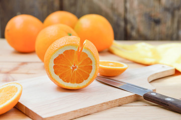 Fresh and juicy half and slice of orange fruit on a chopping blo