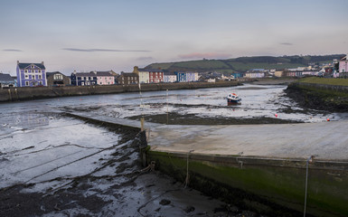 A single boat, in Aberaeron harbour, on the west coast of Wales