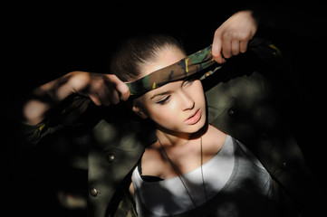 Girl near the brick wall in military style. Lara Croft style.