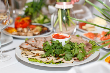 Cutting the meat, tongue, parsley and sauce on a white plate Clo