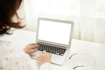 Cropped shot view of young smart mature female businesswomen working on-line via laptop computer, intelligent woman sitting in front open net-book with copy space screen for your text message