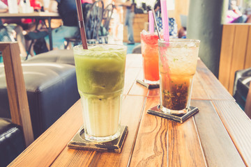Iced green tea latte and other drinks in coffee shop retro filte