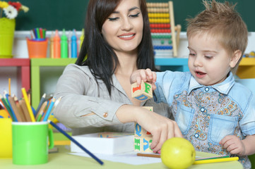 little boy playing  with mother