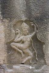 Fototapeta na wymiar Dancing girls carved in the sandstone walls of the Banteay Kdei