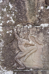 Fototapeta na wymiar Dancing girls carved in the sandstone walls of the Banteay Kdei