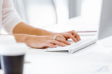Female hands typing on the keyboard