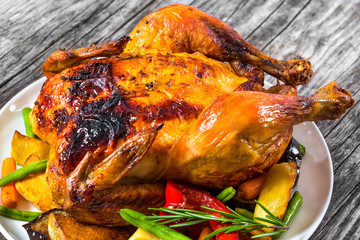 Roasted whole chicken, potatoes, baby carrots, eggplants, green