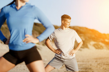 Young couple on beach training together