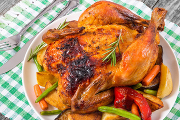 Roasted whole chicken, potatoes, baby carrots, eggplants, green