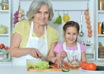 Senior woman with granddaughter cooking