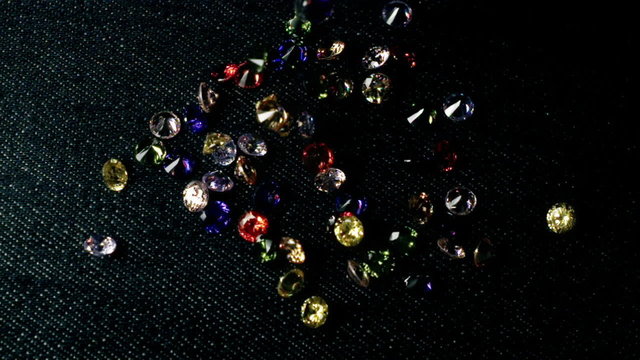 Colorful Zircon Gemstones Falling on Dark Surface Super Slow Motion