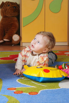 Little boy iying on the carpet