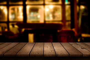 wooden table with a view of blurred restaurant backdrop