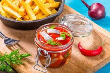 Slices of marinated Norwegian herring, Potato Fries, chili peppe