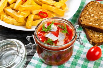 Slices of marinated Norwegian herring, Potato Fries, chili peppe