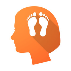 Long shadow female head with two footprints