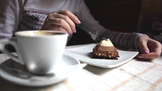 Girl in a Cafe Eating Cake With Three Layers of Chocolate Mousse v2