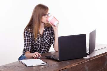 the girl in an Office sitting at a laptop with coffee